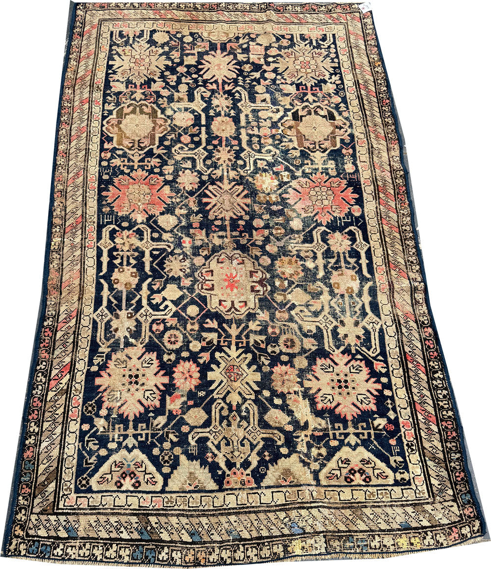 An Antique Decorative Blue Ground Worn Out Caucasian Rug