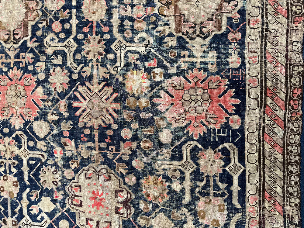 An Antique Decorative Blue Ground Worn Out Caucasian Rug