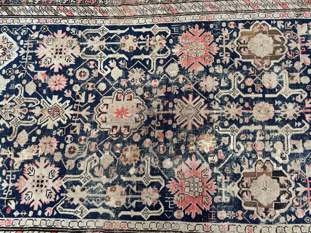 An Antique Decorative Blue Ground Worn Out Caucasian Rug