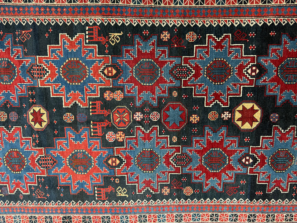An Antique Decorative Blue Ground Caucasian Shirvan Rug