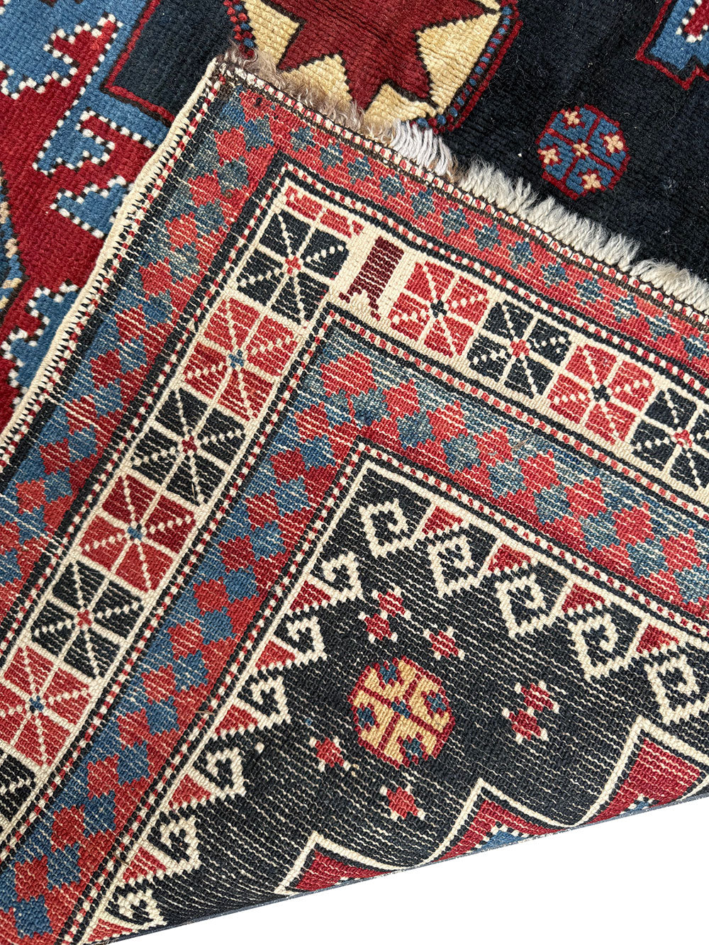 An Antique Decorative Blue Ground Caucasian Shirvan Rug